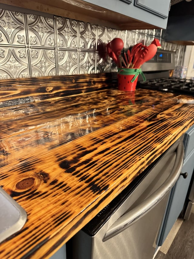 details with wooden counters and stainless steel gas range oven