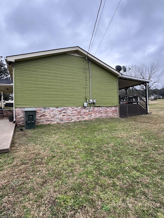 view of side of home with a lawn