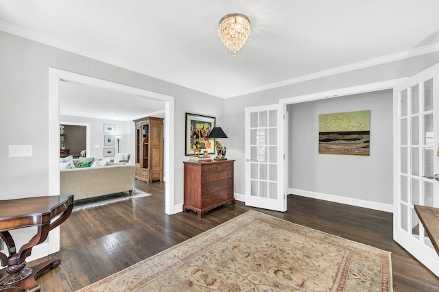 interior space featuring french doors, dark wood-type flooring, ornamental molding, and a notable chandelier