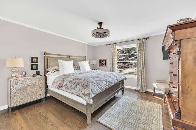 bedroom featuring dark hardwood / wood-style flooring and crown molding