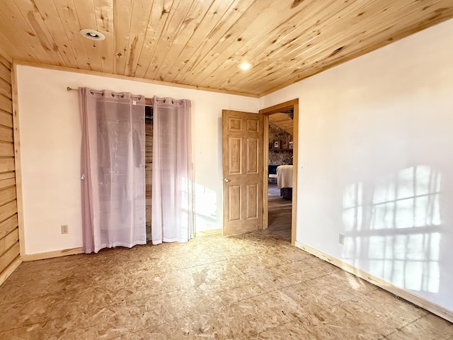 unfurnished room with wooden ceiling