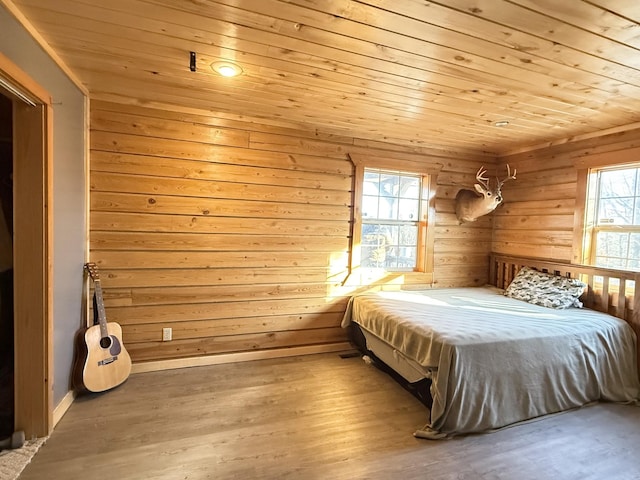 bedroom with light hardwood / wood-style flooring and wood ceiling