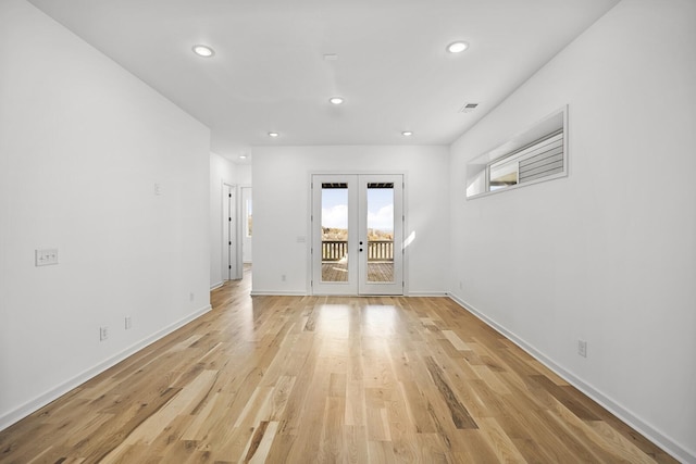 unfurnished room with light wood-type flooring and french doors