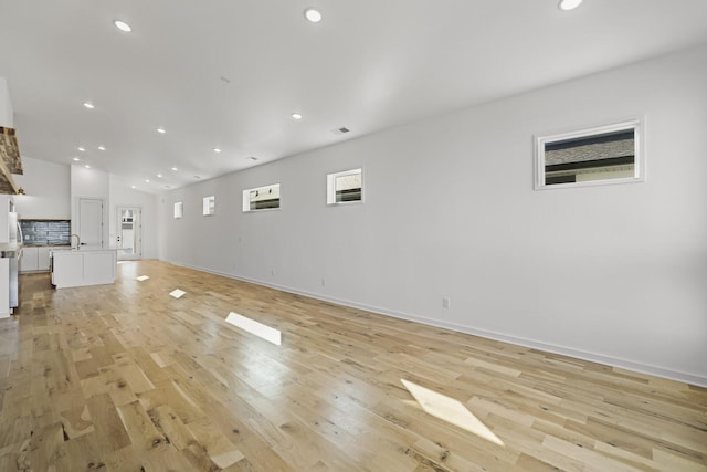 unfurnished living room with light hardwood / wood-style flooring