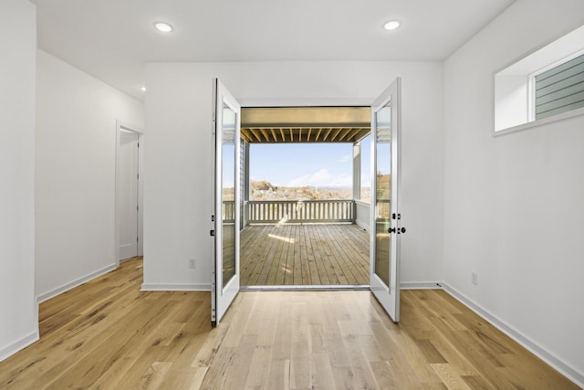 entryway featuring french doors and light hardwood / wood-style flooring