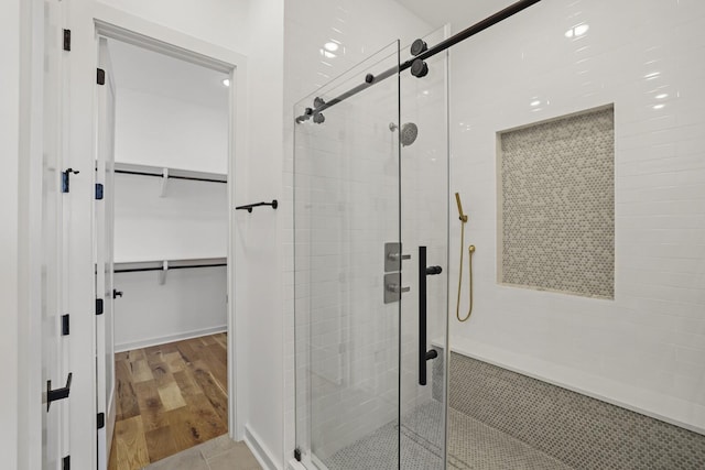 bathroom featuring wood-type flooring and walk in shower