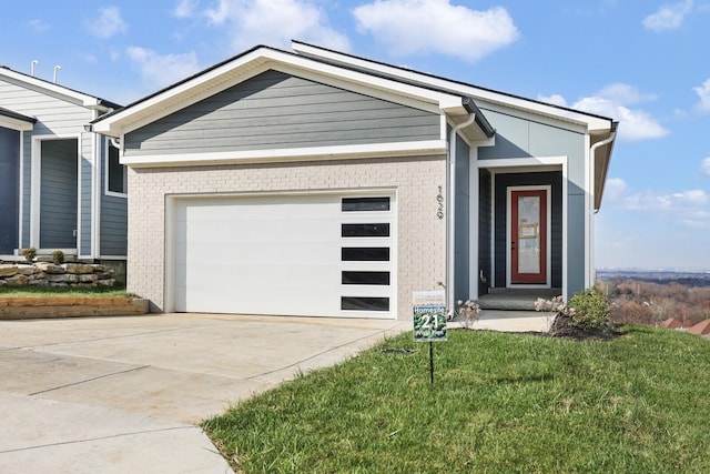 view of front of home with a front lawn and a garage