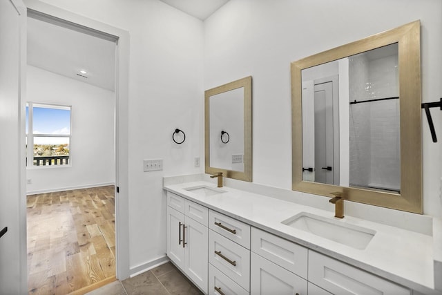 bathroom with lofted ceiling, vanity, and tile patterned flooring