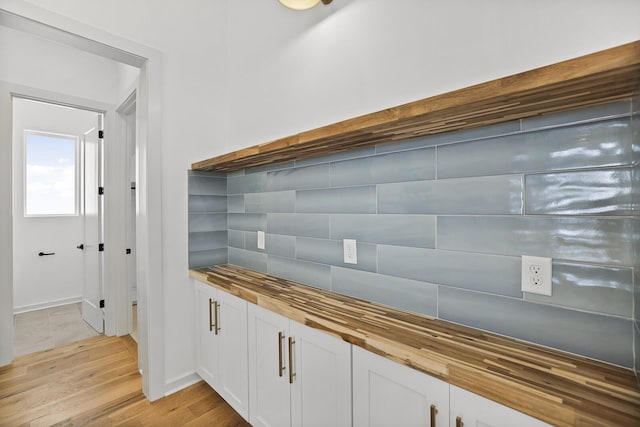 details featuring hardwood / wood-style floors and tasteful backsplash