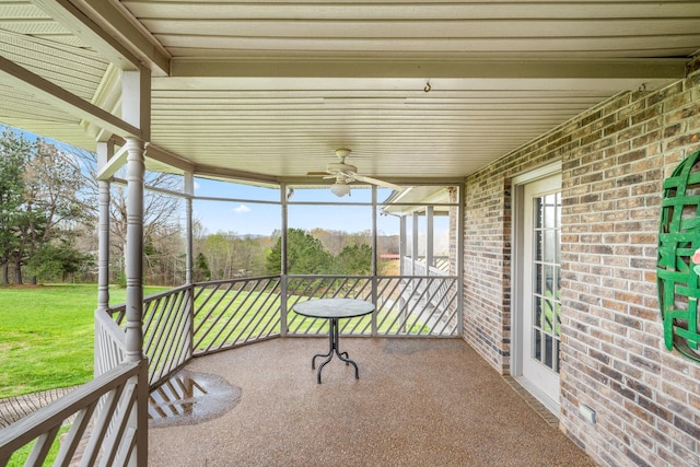 unfurnished sunroom with ceiling fan