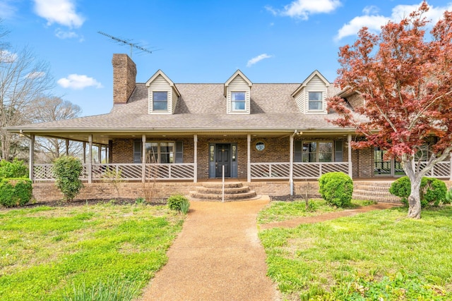 view of front of property with covered porch and a front yard