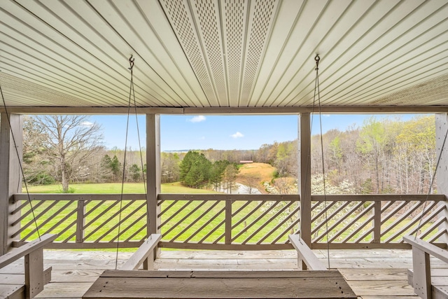 unfurnished sunroom featuring a water view