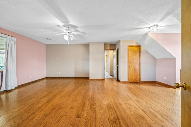 interior space featuring light hardwood / wood-style floors, a textured ceiling, and ceiling fan