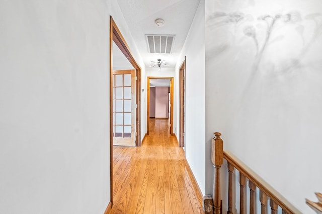 hall with light hardwood / wood-style floors