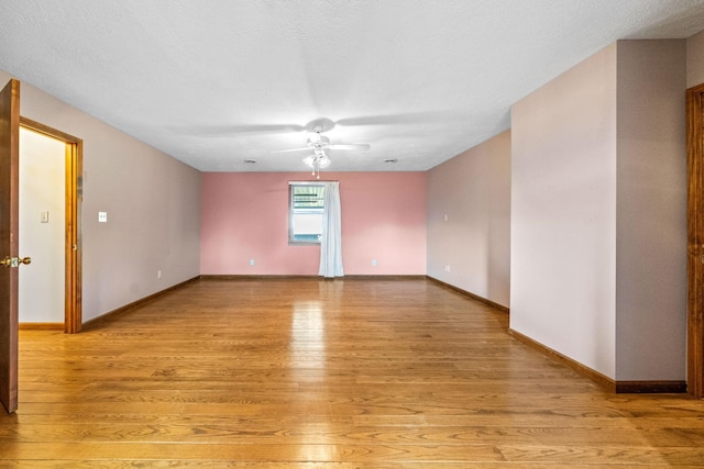 unfurnished room with a textured ceiling and light hardwood / wood-style flooring