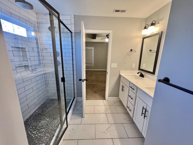 bathroom with ceiling fan, walk in shower, and vanity