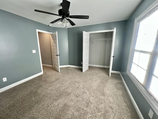 unfurnished bedroom with carpet floors, a closet, a ceiling fan, and baseboards