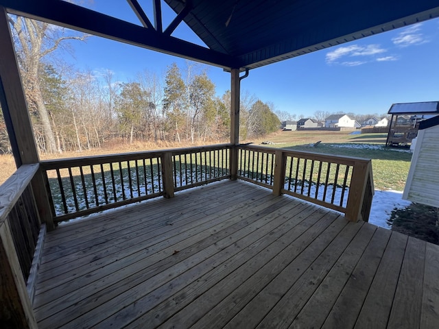 wooden terrace featuring a yard