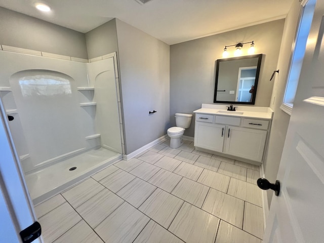 full bathroom featuring baseboards, vanity, toilet, and walk in shower