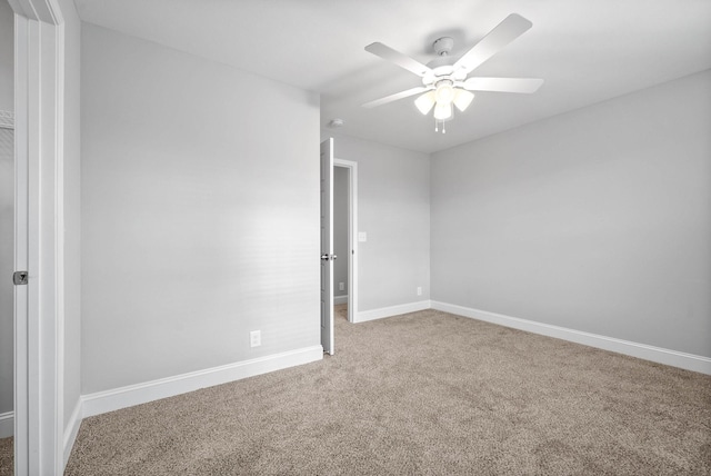 empty room with ceiling fan and carpet flooring