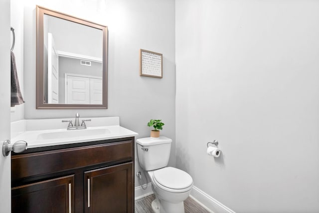 bathroom featuring toilet and vanity