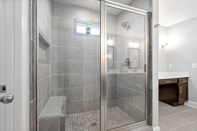 bathroom featuring a shower with shower door and tile patterned flooring