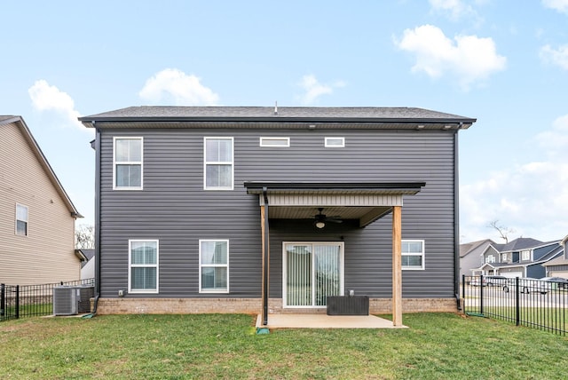 rear view of house featuring ceiling fan, central AC unit, a patio, and a yard