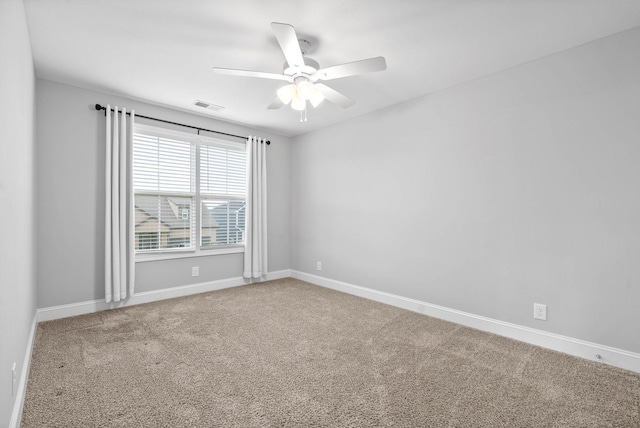 carpeted spare room with ceiling fan