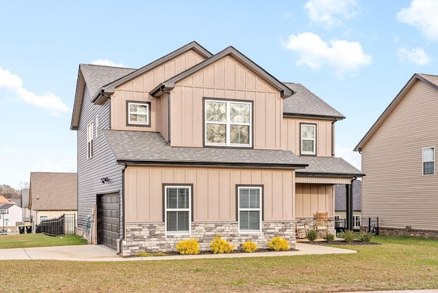 view of front of house featuring a front lawn and a garage