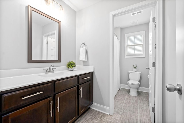 bathroom with toilet and vanity