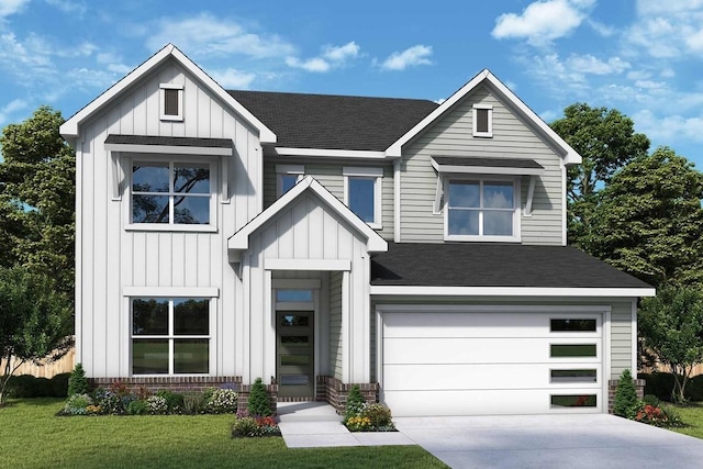 view of front of property with a front yard and a garage