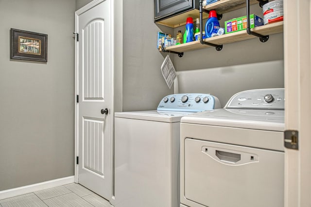 laundry room with washing machine and dryer and cabinets