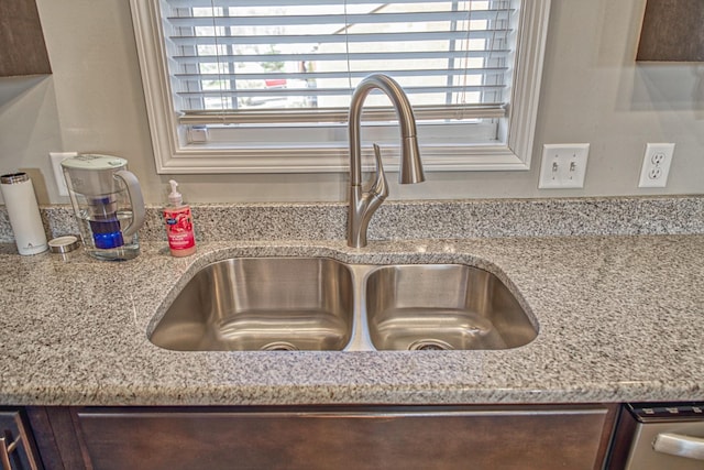 interior details with light stone countertops and sink