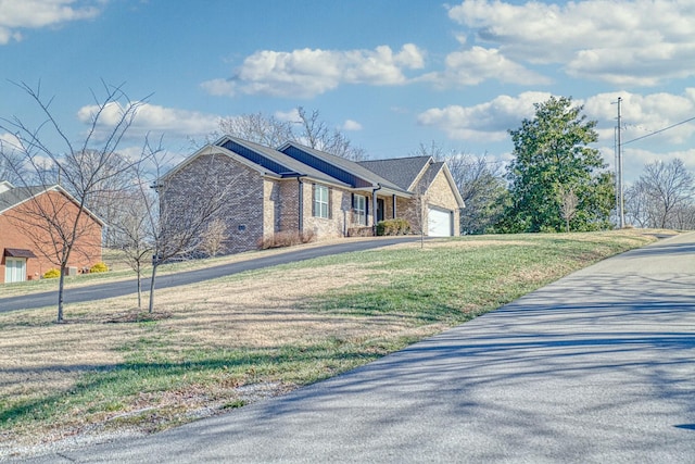 view of front of property with a front yard and a garage