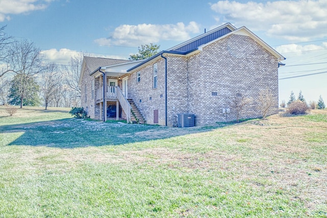 view of property exterior with a lawn and central air condition unit