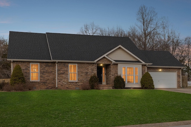 view of front facade featuring a garage and a lawn