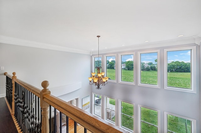 interior details featuring crown molding and an inviting chandelier