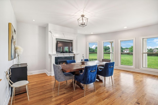 dining room with a notable chandelier and light hardwood / wood-style flooring