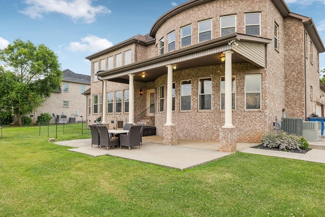 back of property featuring a patio area and a yard