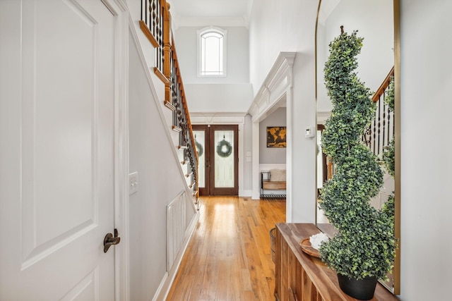 foyer entrance featuring a high ceiling and light hardwood / wood-style floors