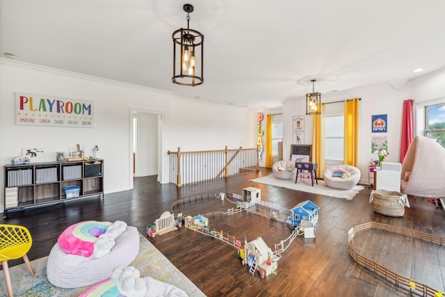 living room with dark wood-type flooring and crown molding