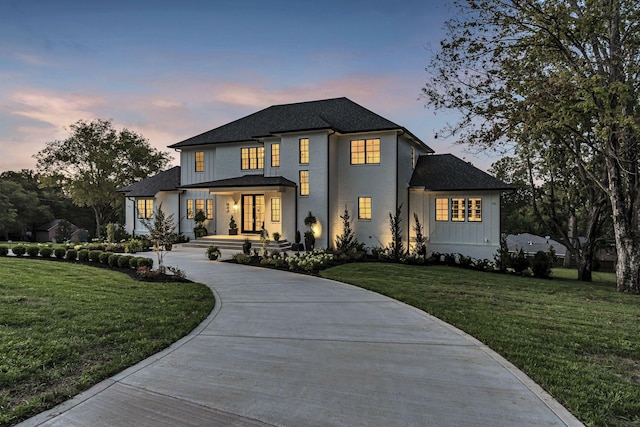 view of front of home with a lawn and a porch