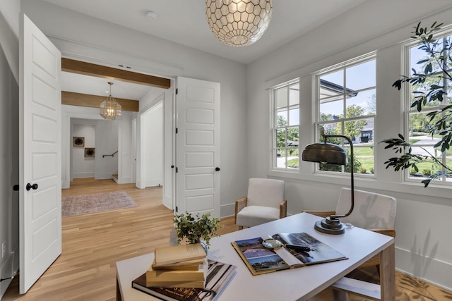 office space featuring light hardwood / wood-style floors and an inviting chandelier