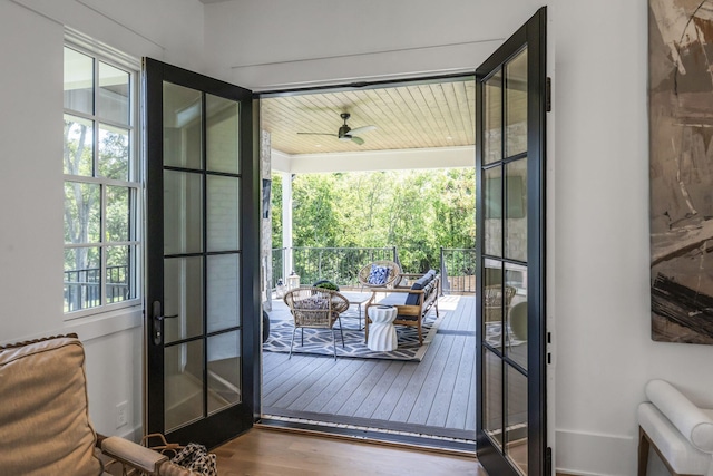 doorway featuring ceiling fan, hardwood / wood-style floors, and french doors