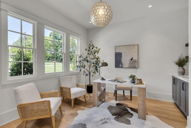 home office with light hardwood / wood-style flooring