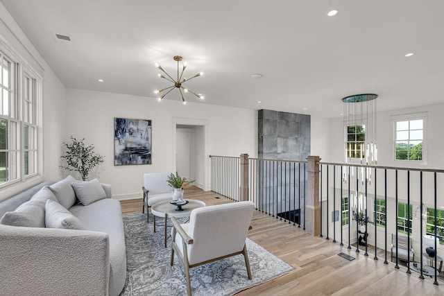 living room featuring an inviting chandelier and light hardwood / wood-style flooring