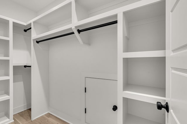 spacious closet with light hardwood / wood-style floors