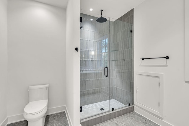 bathroom with toilet, tile patterned floors, and an enclosed shower