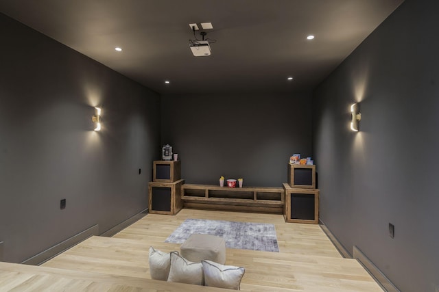 home theater room with light hardwood / wood-style flooring