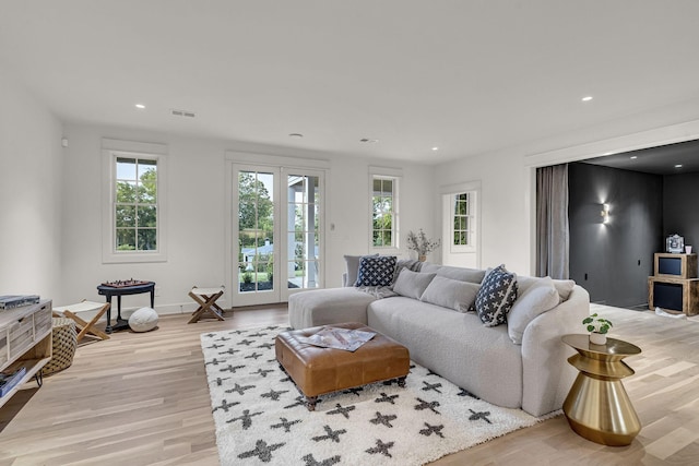 living room with light hardwood / wood-style flooring and french doors